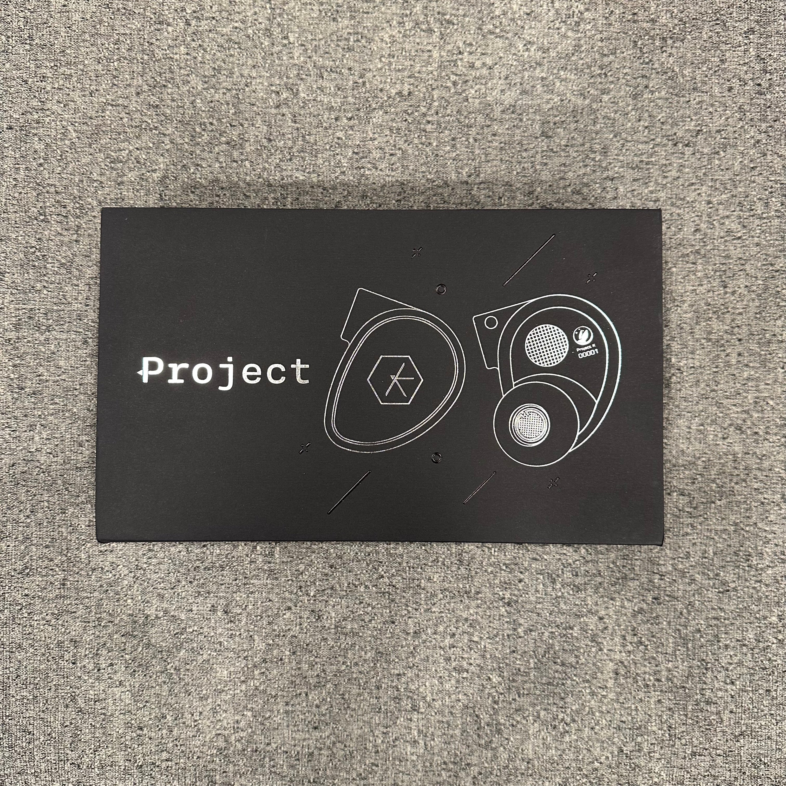 Black card with white text and graphics on a textured gray surface