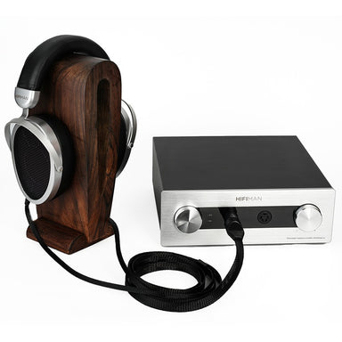 hifiman mini shangri-la amplifier with headphones on a stand