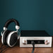 hifiman mini shangri-la headphone front view on a table with amplifier