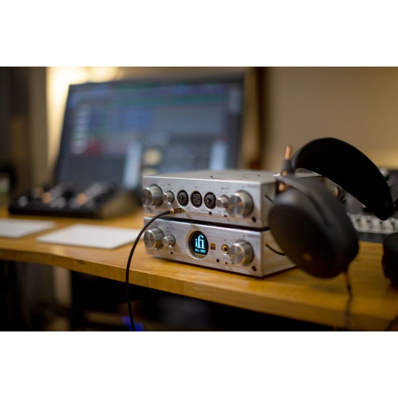 ifi audio pro ican studio headphone amplifier on a pc desk with headphones
