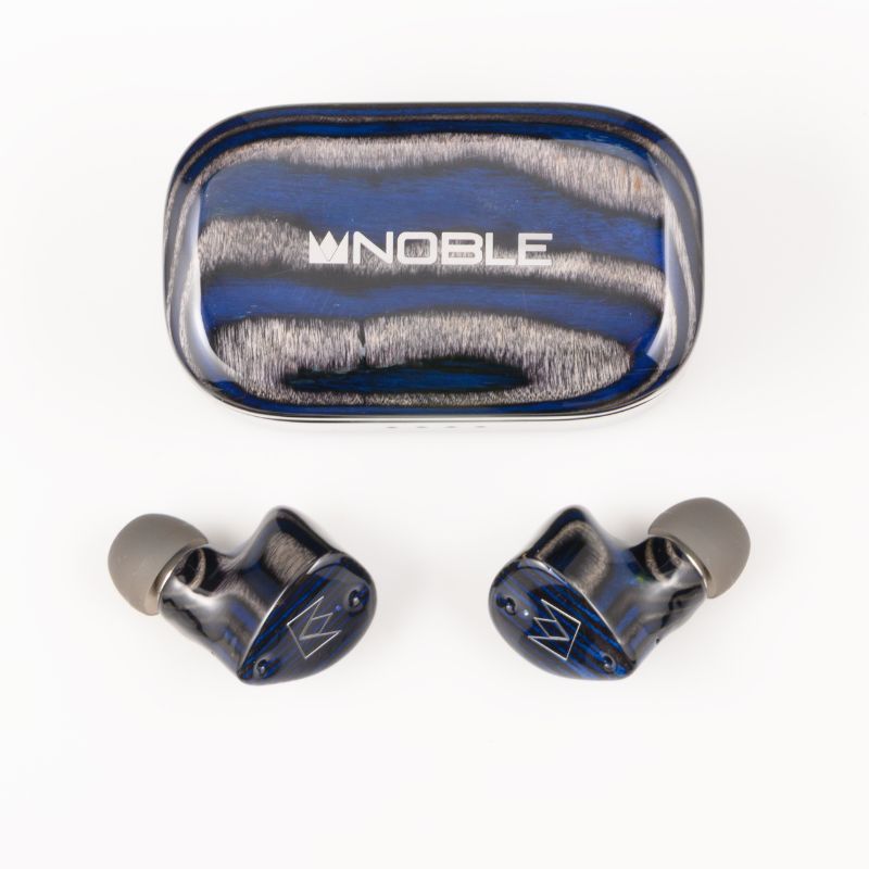 noble audio fokus prestige encore earbuds outside the closed charging case