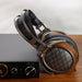 sendy audio egret headphone next to an amp