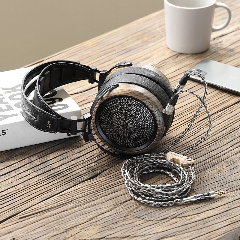 sendy audio peacock headphone black on a wood table