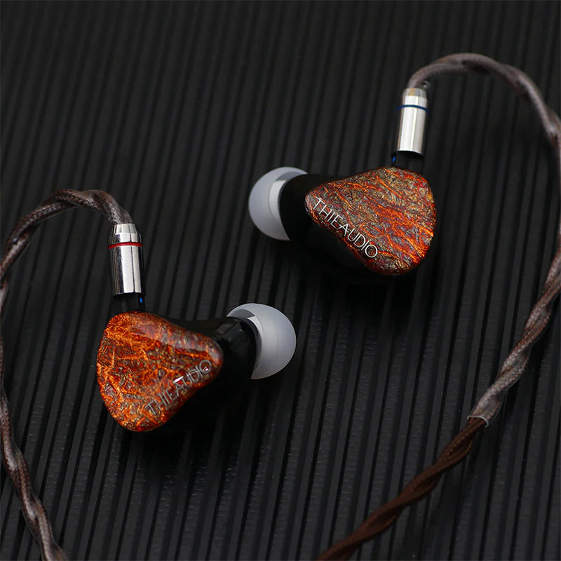 thieaudio monarch mk2 iems with cable plugged in on black surface